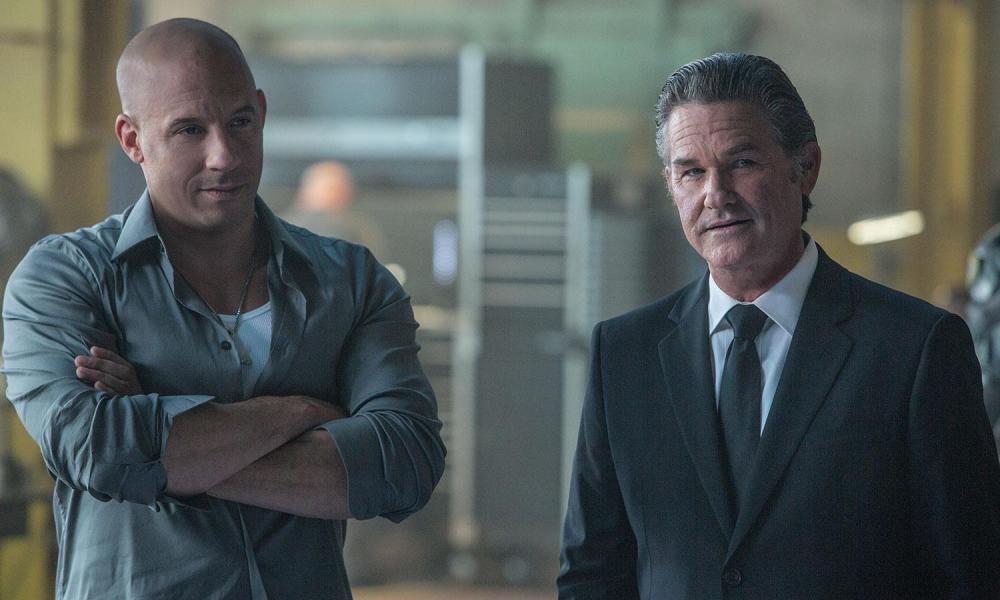 Vin Diesel stands next to Kurt Russell in Furious 7.