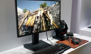 A gaming monitor sitting on a desk.