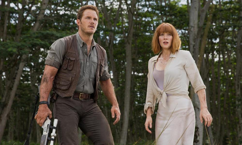 A man and woman stand next to each other in Jurassic World.