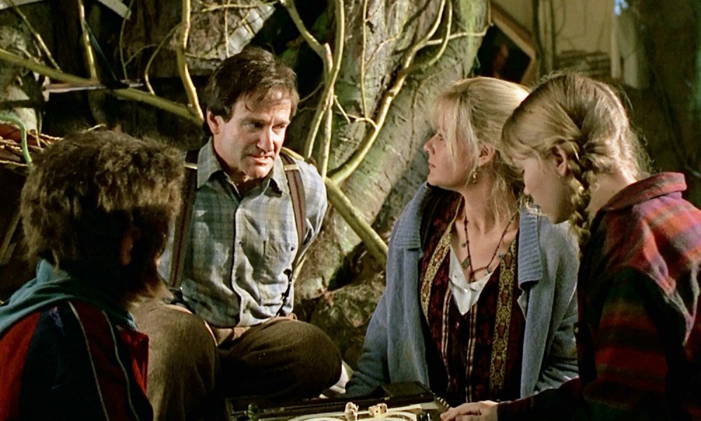 Robin Williams, Bonnie Hunt, and the kids sit around a table in Jumanji.