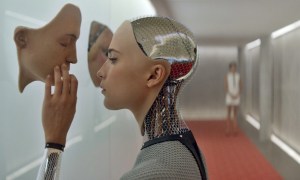 An android touches a face on the wall in Ex Machina.