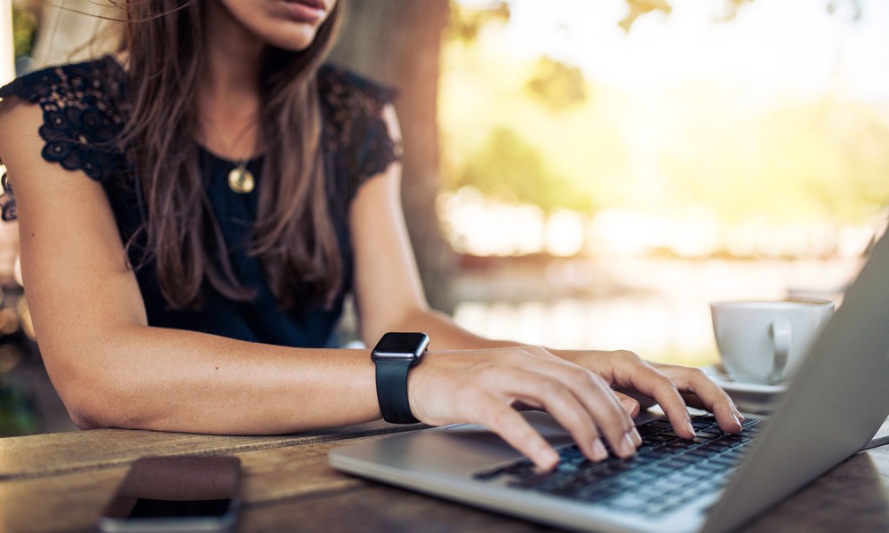 A person typing on a laptop.