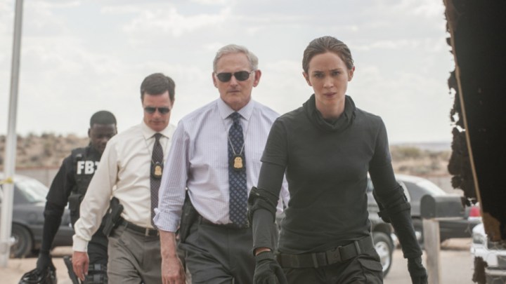 Emily Blunt and multiple agents walk toward the camera in Sicario.