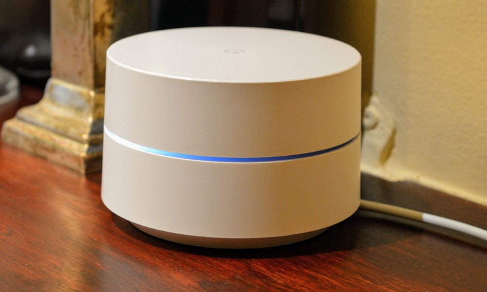 The Google Wifi device with light coming from the center.