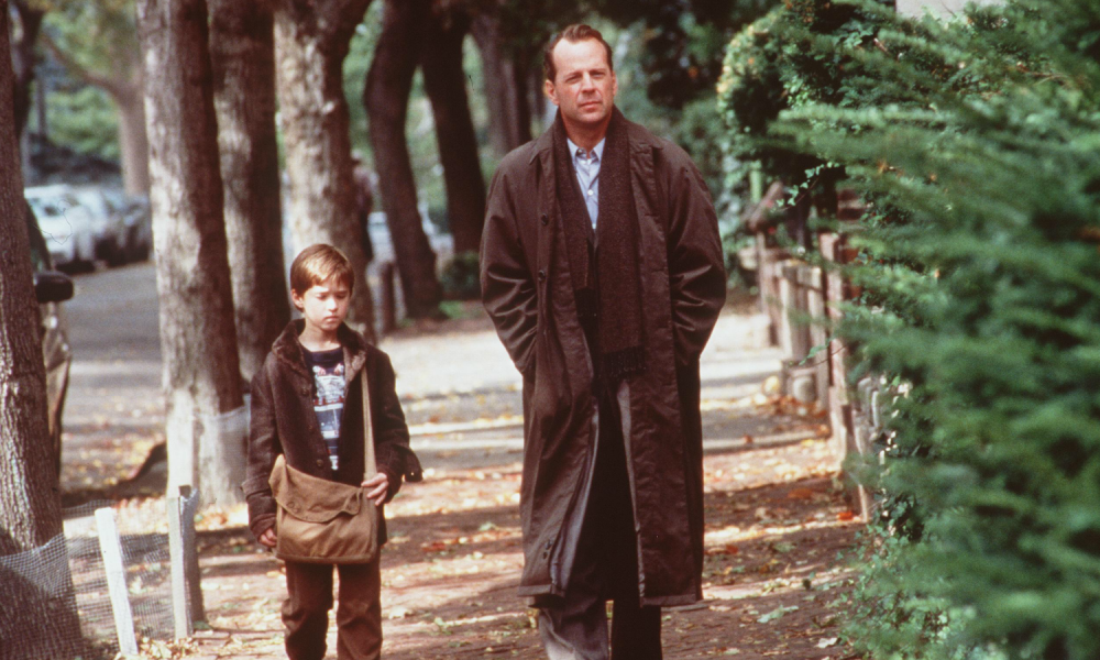 A man and a young boy walk alongside each other in The Sixth Sense.