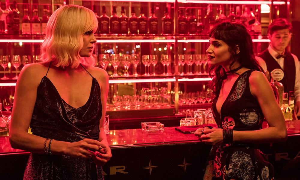 Two women stare at each other at the bar.