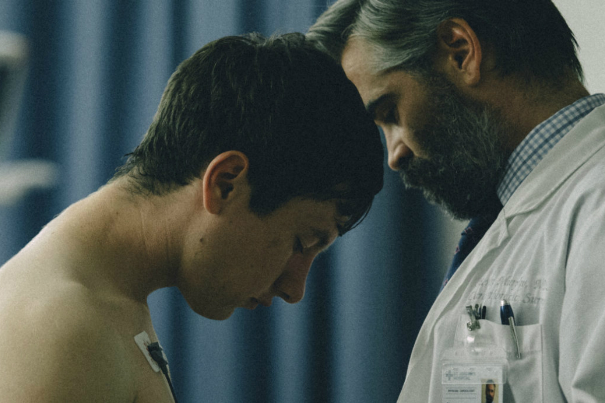 Two men bow their heads in The Killing of a Sacred Deer.