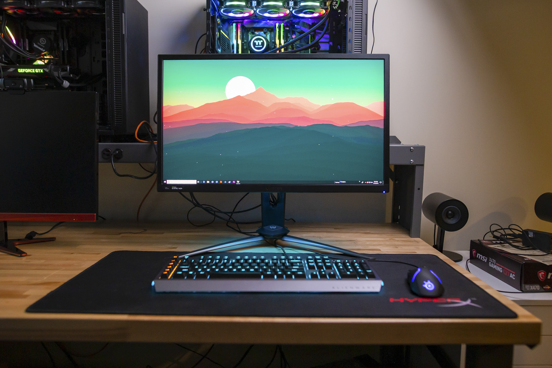 Acer Predator XB3 Gaming Monitor on a desk surrounded by other computer equipment.