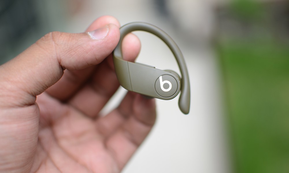 A person holding the Beats Powerbeats Pro.