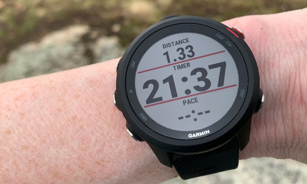 A Garmin Forerunner 235 Music smartwatch on a wrist.