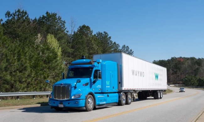 A Waymo autonomous trick undergoing testing on a highway.