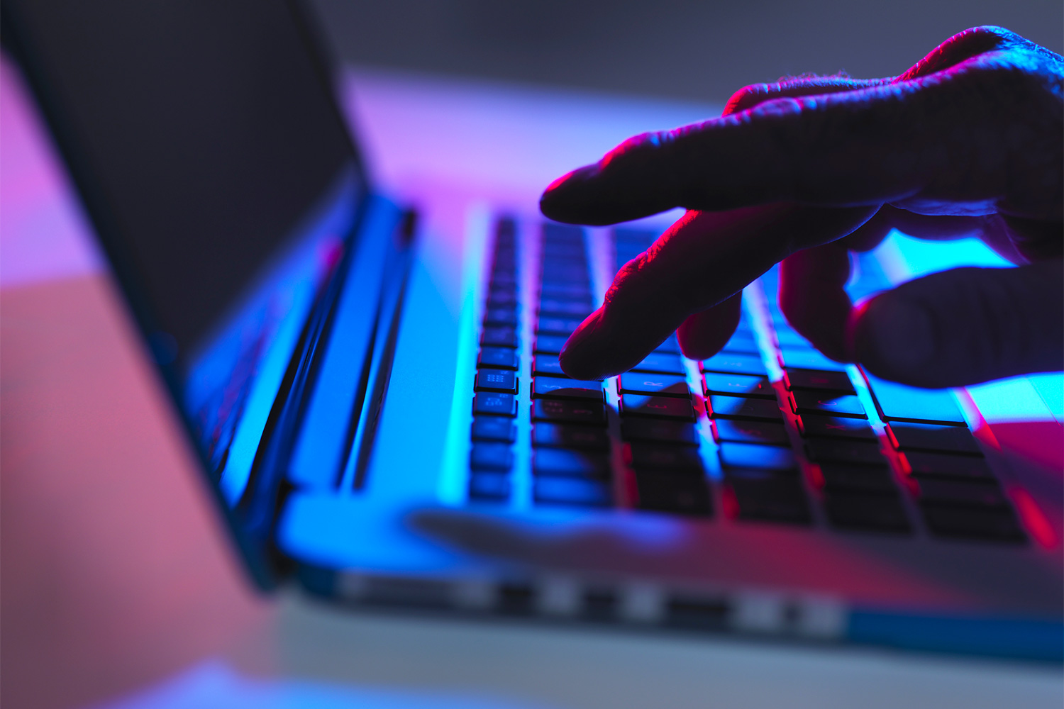 Person typing on a computer keyboard.