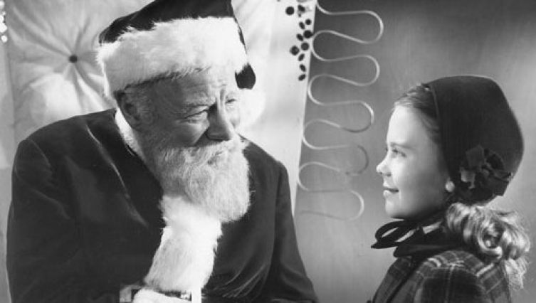 Santa looks at a girl in Miracle on 34th Street.