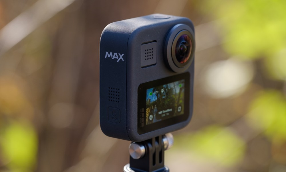 A GoPro Max on a tripod in the woods.