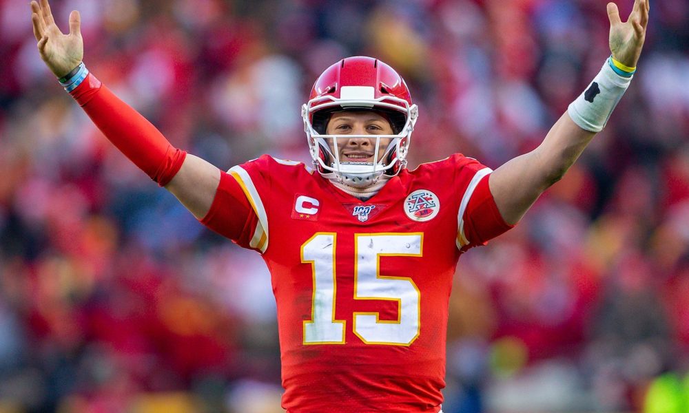 Patrick Mahomes holds his arms up.