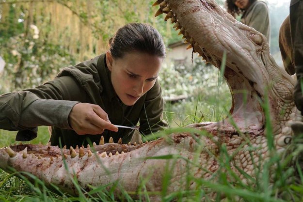 Natalie Portman as Lena looking inside the mouth of a crocodile in the film Annihilation.