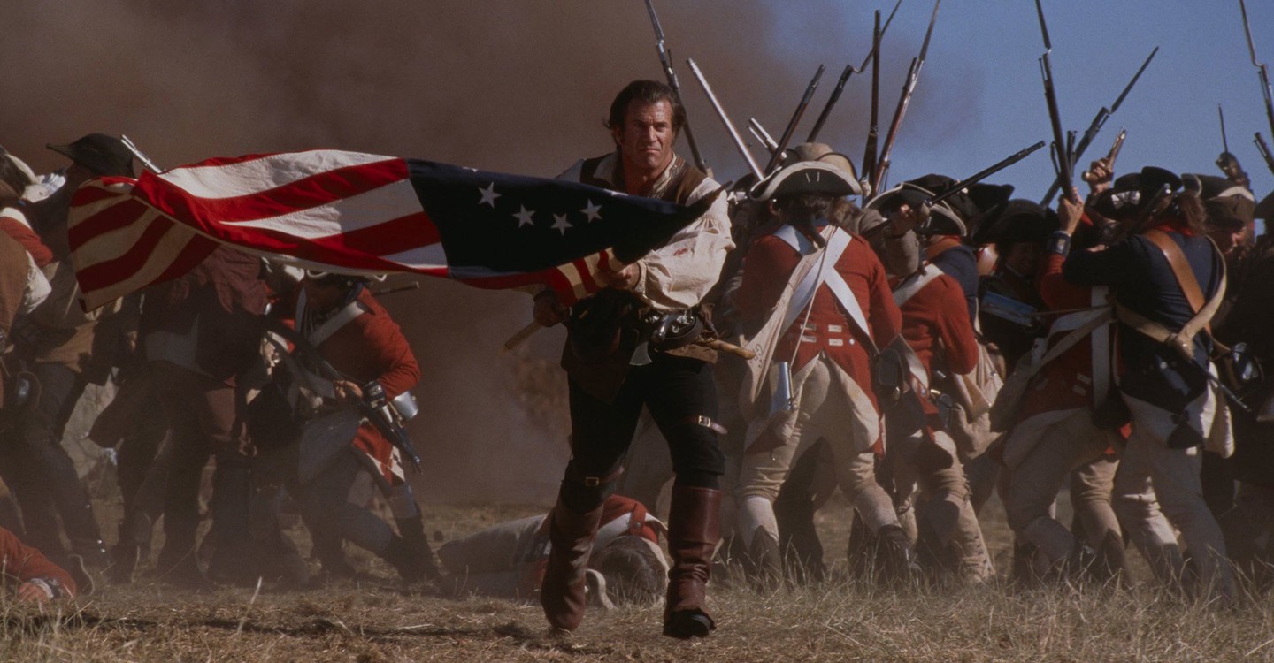 Mel Gibson runs with an American flag.