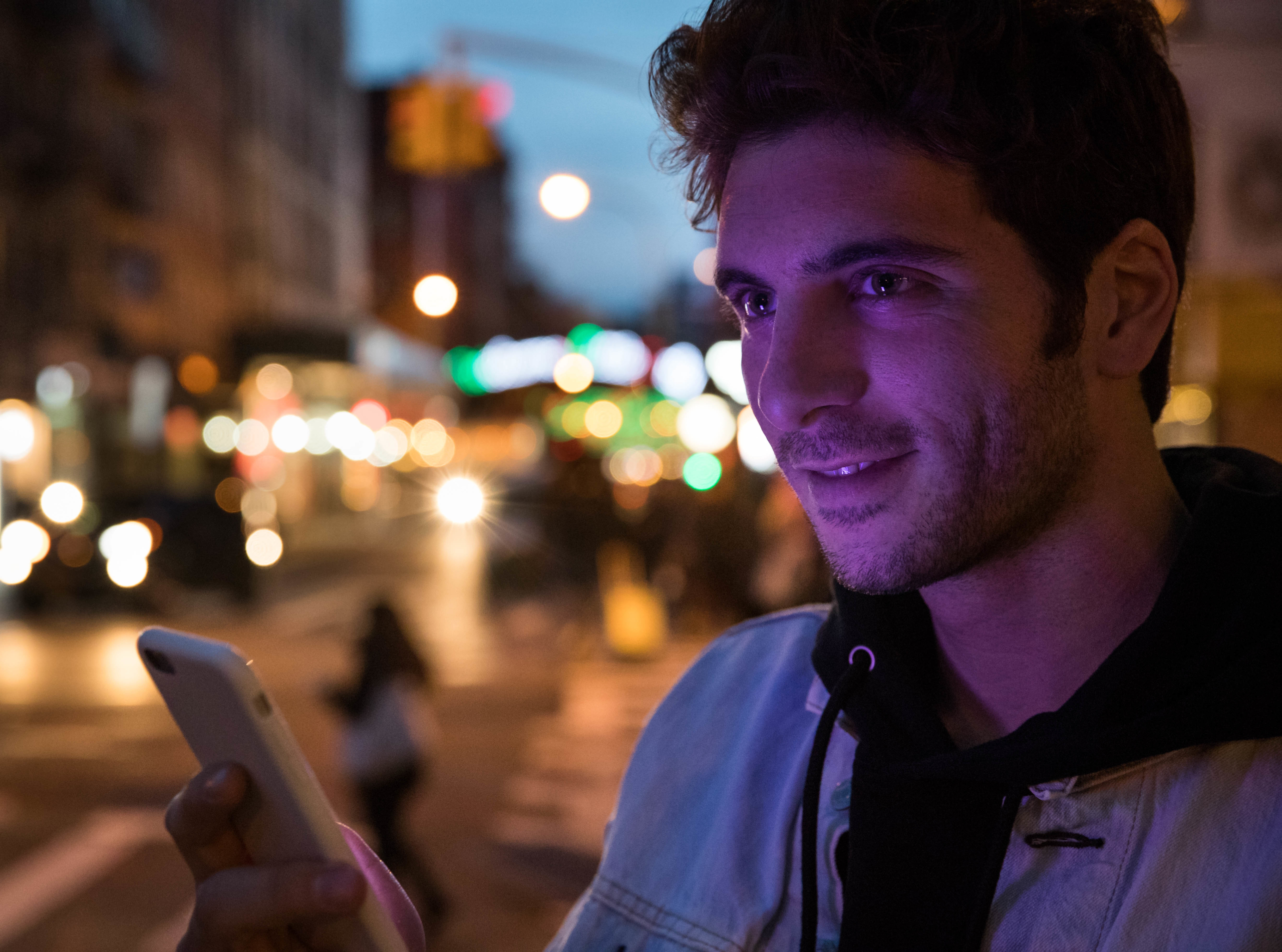 Picture of man at night on his cell phone