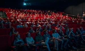 People sit in a movie theater.