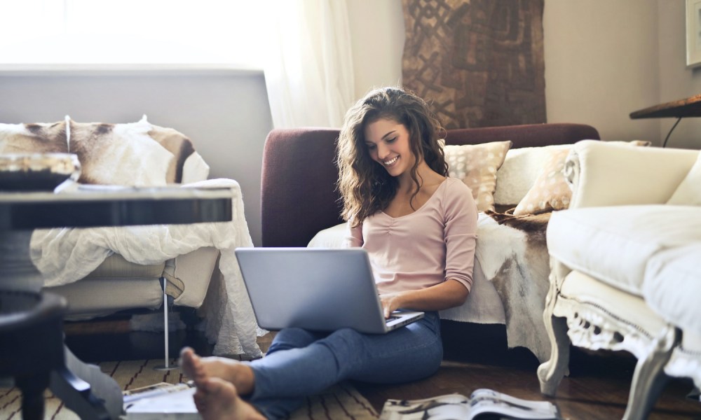 woman sitting and using laptop