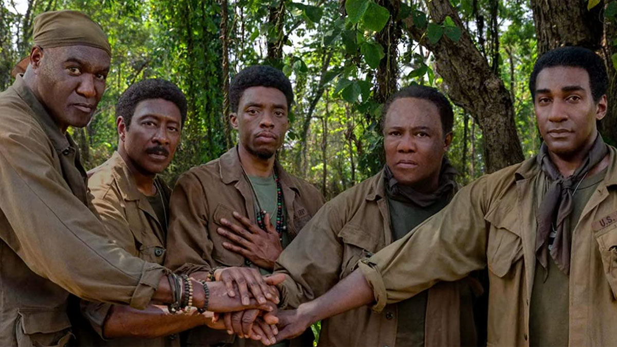 Da 5 Bloods de Spike Lee presenta a cinco soldados negros tomados de la mano y mirando a la cámara.