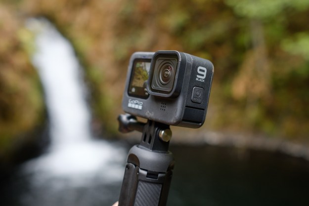 The GoPro Hero 9 Black with a waterfall in the background.