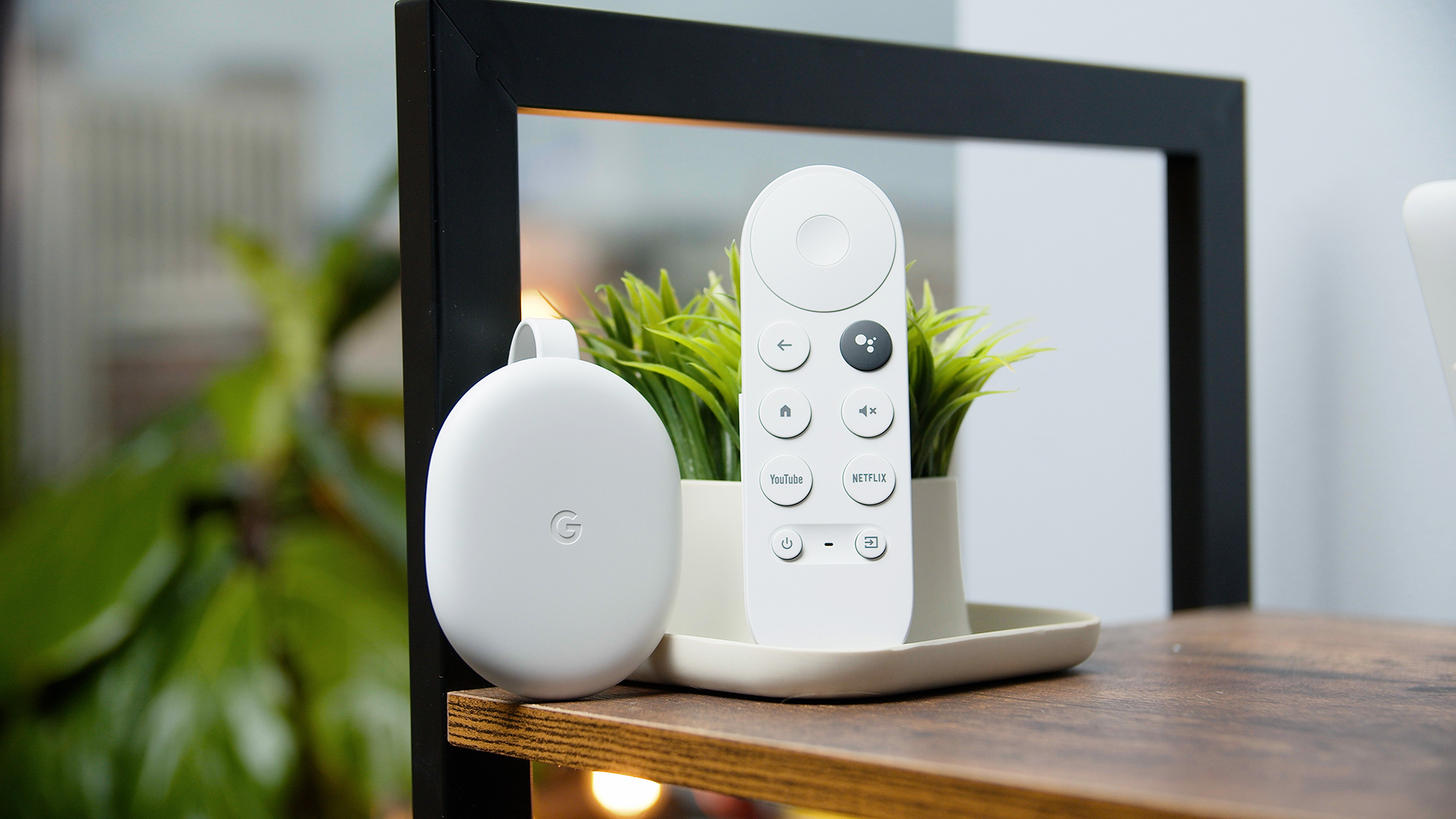 Google Chromecast with Google TV displayed on a shelf.