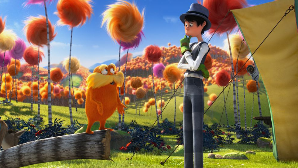 A boy talks to an orange creature in The Lorax.