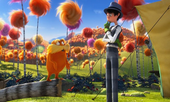 A boy talks to an orange creature in The Lorax.