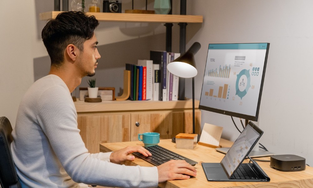 A person works on a computer in a home office.