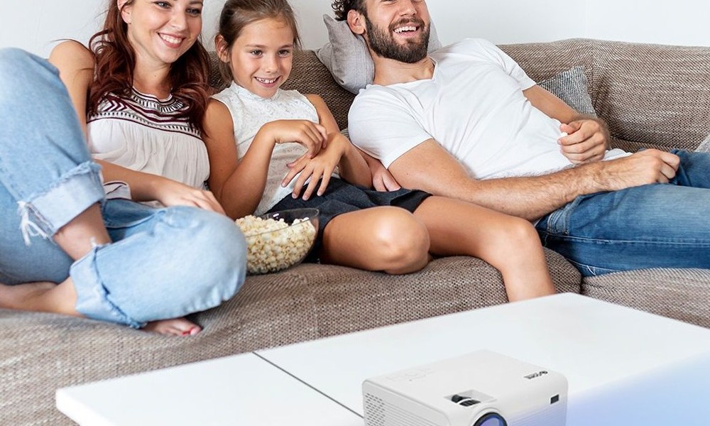 Family watching home projector.