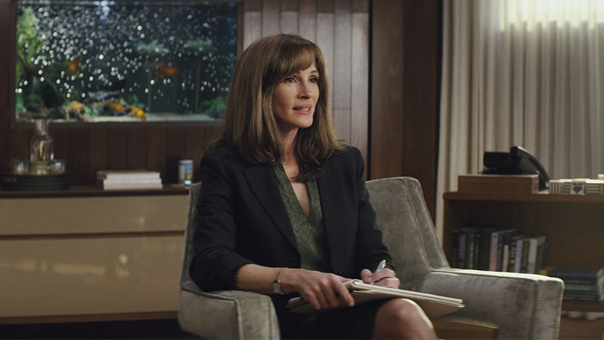 Julia Roberts sentada em um sofá em uma cena de Homecoming.