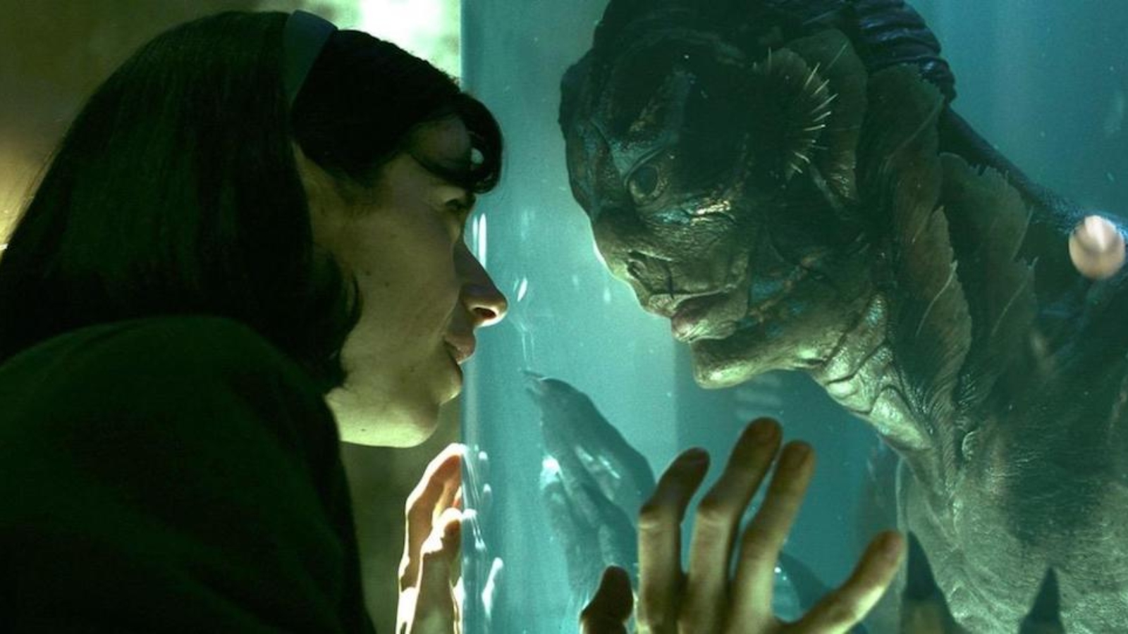 A woman and a creature tough glass in The Shape of Water