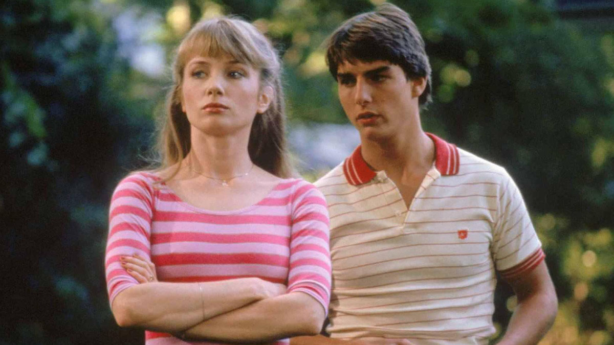 A man and woman stand beside each other in Risky Business.