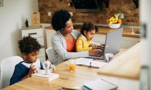 A woman and her kids using the Acer Chromebook 317 while sitting at a desk.