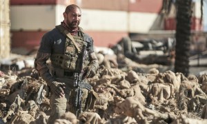 Dave Bautista wades through a pile of dead bodies in a scene from Army of the Dead.Army of the Dead