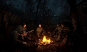 Survivors around a camp fire in Stalker 2.