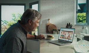 Man uses Microsoft Teams on a laptop in order to video chat.