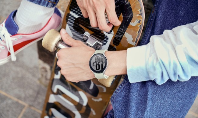 Person holding skateboard while wearing the Samsung Galaxy Watch 4.