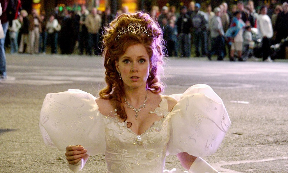 Amy Adams in Enchanted standing in a fancy white dress, her hair done up and looking worried.