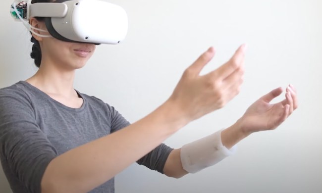 A woman in a VR headset holding her hands out.