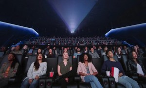 Movie theater audience watching Dolby Cinema content.