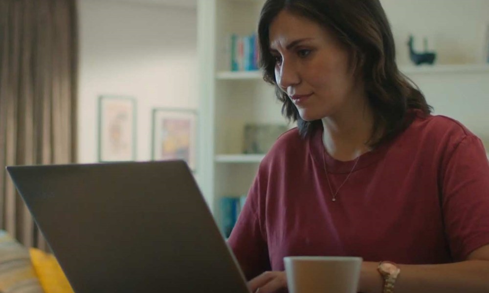 Woman using Sign Easy on laptop to sign documents.