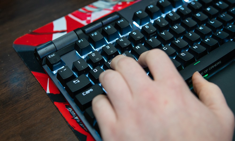 Fingers on WASD on a gaming keyboard.