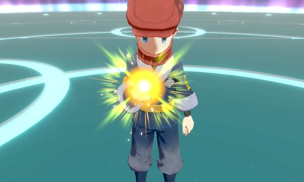 A trainer holding a glowing Pokéball.