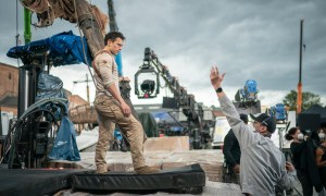 Tom Holland stands on set as Nathan Drake in Uncharted.