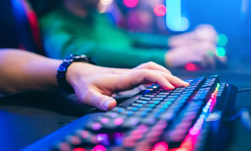 A closeup of gamer using a mechanical keyboard with rgb lighting