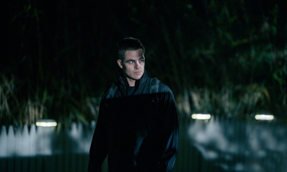 Chris Pine stands in the shadows in a scene from The Contractor.