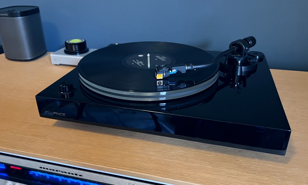 The Fluance RT85N turntable in piano black on a media unit.