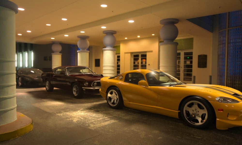 Three luxury cars weight in a line outside a Miami hotel.